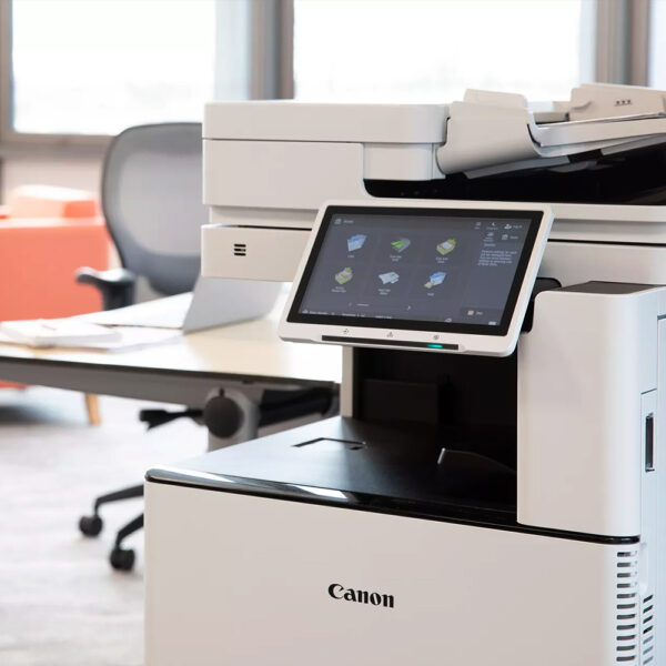 Close up view of a modern Canon multifunction printer copier scanner with touch pad screen in an office space
