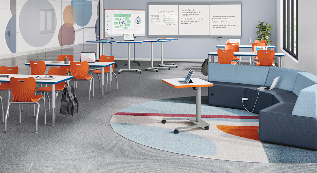3D Rendering of a classroom with trendy lounge area and rolling adjustable height desk-to-podiums, group project tables with smart boards and dry erase boards