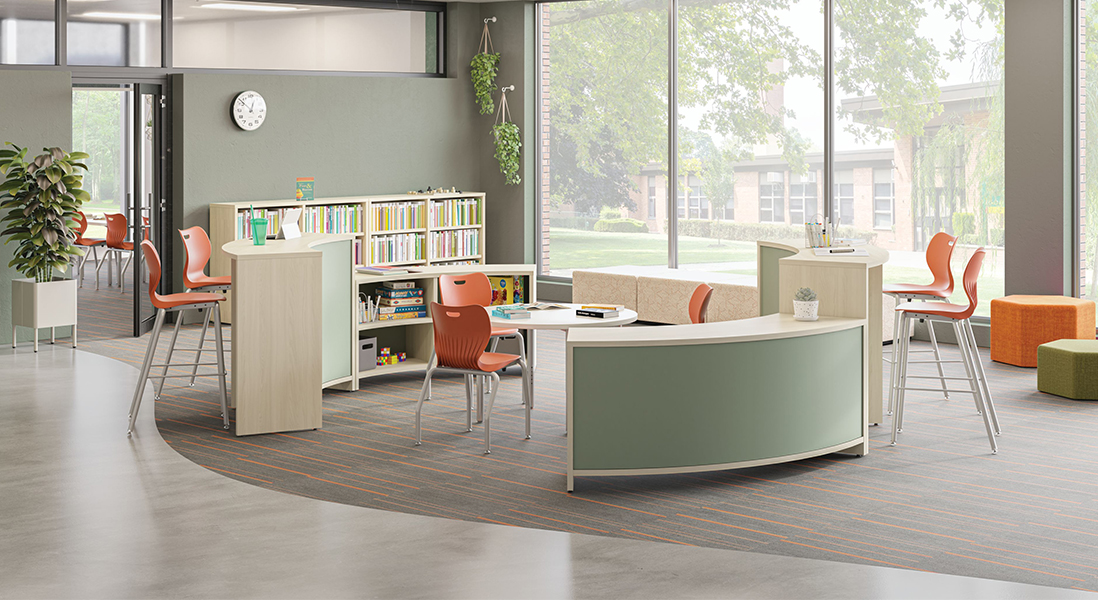 MCM Library children's section with fun curved bookshelves and various shapes for seating with taller work stations for adults and an easy-clean activities table