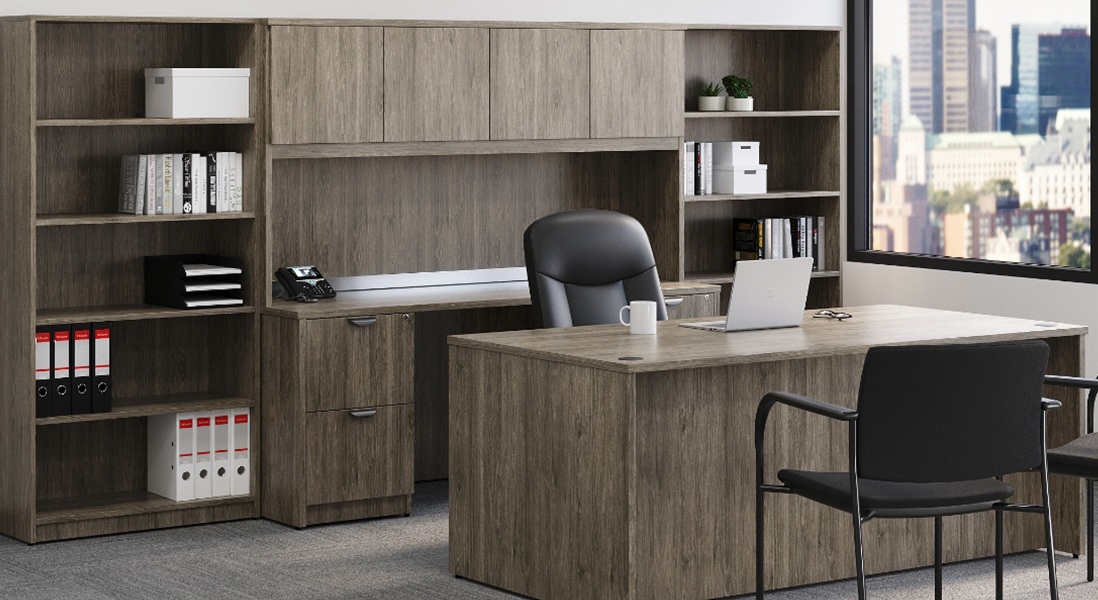 Traditional executive office with wood pattern furniture and comfy chairs with hidden and visible storage along with space to meet clients