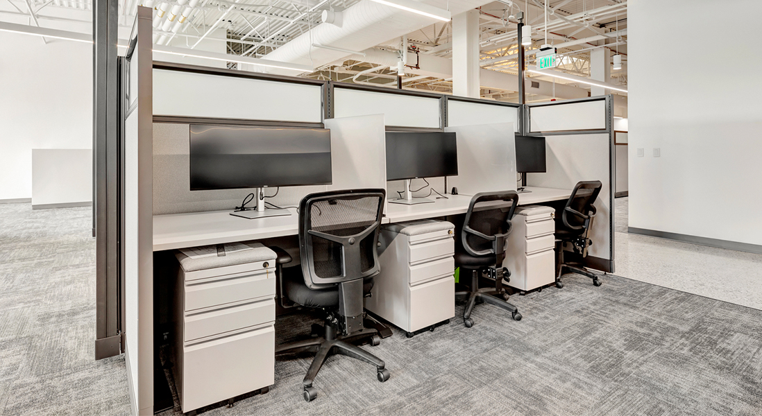 Modern office space co-working station made from modular walls, moveable storage and ergonomic chairs