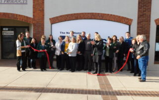 River Bend Business Products employees performing a ribbon cutting ceremony at their New Ulm, Minnesota location with the New Ulm Chamber of Commerce
